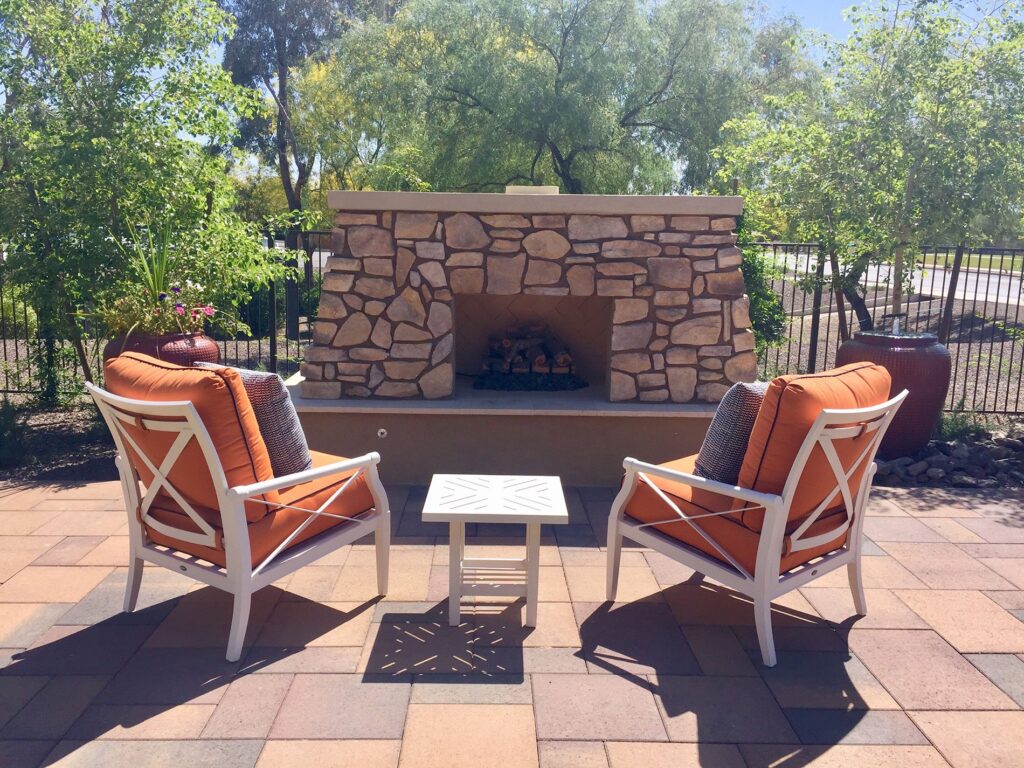 Patio with stone fireplace and seating