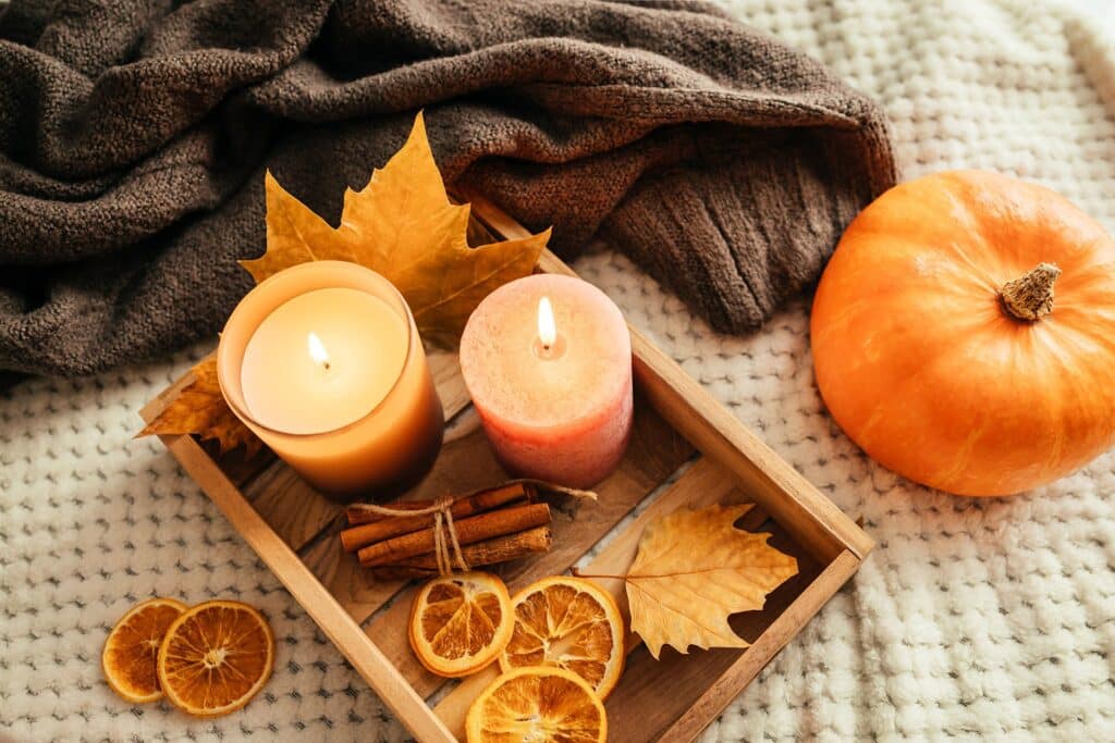 Candles, cinnamon sticks, and pumpkin decor